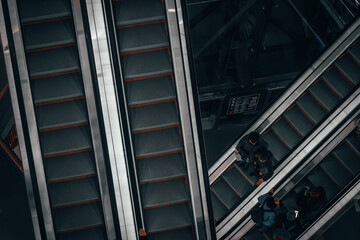 People on the escalator in the mall, top view. Saint Petersburg, Russia - 2 Feb 2024