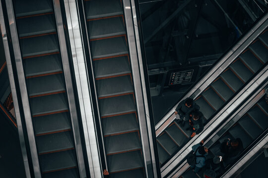 People on the escalator in the mall, top view. Saint Petersburg, Russia - 2 Feb 2024