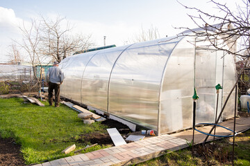 An empty greenhouse in the country in early spring.