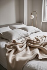 soft beige blanket draped over a cozy bed with gray pillows in a bright modern bedroom