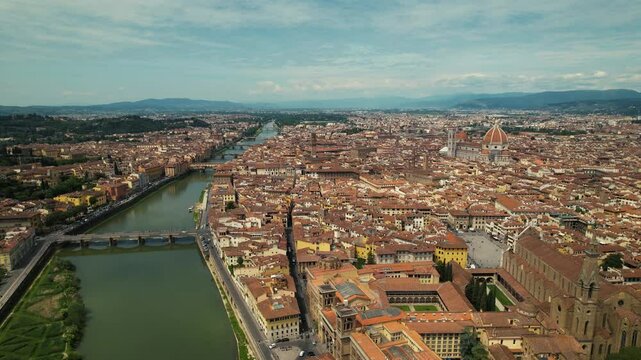 Drone aerial view shot of Florence skyline, Cathedral of Saint Mary of the Flower, Ponte Vecchio and The Arno River, Tuscany region, Italy