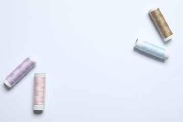 Composition with sewing threads on a white background