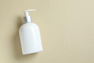 Cosmetic bottle on color background, top view