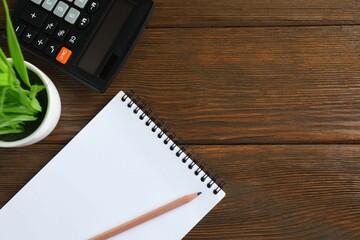 Top above overhead view photo of office accessories calculator, notebook on gray backdrop with blank empty space