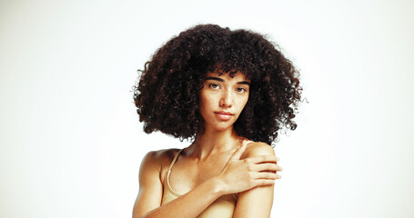 Obraz premium Portrait, space and afro woman with hair care, studio and treatment for wellness and health. Face, growth or confident girl model with beauty, volume and natural texture on white background in Brazil