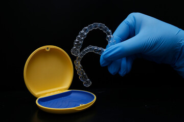 Treatment with clear aligners by a dental orthodontic specialist. Alignment of misaligned teeth known as aligner therapy. © UniqDream