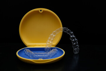 Treatment with clear aligners by a dental orthodontic specialist. Alignment of misaligned teeth known as aligner therapy. © UniqDream