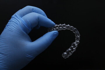 Treatment with clear aligners by a dental orthodontic specialist. Alignment of misaligned teeth known as aligner therapy. © UniqDream