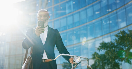 Bike, phone and smile with business black man outdoor in city for communication or commute. Building, directions on mobile app or search and mature employee with green transportation for cycling
