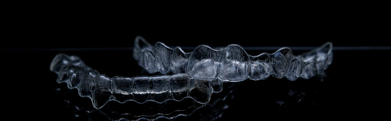 Treatment with clear aligners by a dental orthodontic specialist. Alignment of misaligned teeth known as aligner therapy. © UniqDream