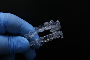 Treatment with clear aligners by a dental orthodontic specialist. Alignment of misaligned teeth known as aligner therapy. © UniqDream