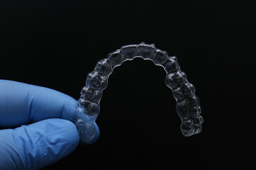 Treatment with clear aligners by a dental orthodontic specialist. Alignment of misaligned teeth known as aligner therapy. © UniqDream