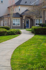 View of home with front lawn and a walkway. . Front yard walkway