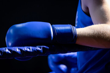 Boxer's Hand Resting on the Ropes During a Fight