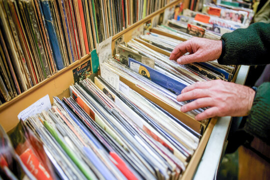 Person browsing vinyl records in a store