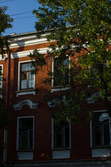 Facade of a red brick house with Victorian style windows