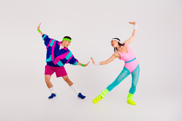 Energetic couple in vibrant retro sportswear dancing against a white background, capturing the essence of 80s aerobics with dynamic poses