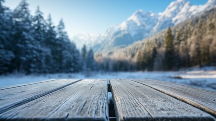 Fototapeta premium Close-up of a wooden picnic table with a frosted surface and snowy mountain landscape in the background. Concept of winter picnic, trekking, and outdoor activities.