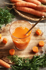 A glass of fresh carrot juice with ecological paper straw. Zero waste.