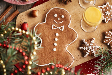 Cute man shaped gingerbread Christmas cookie with a glass of Eiecognac