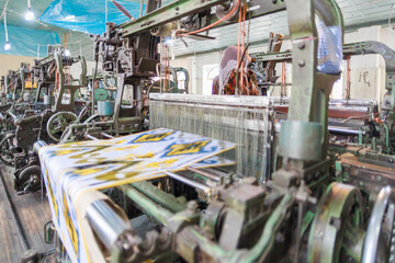 A beautiful carpet on a loom during the sewing process.