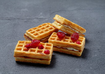 Belgian waffle sandwiches filled with sweetened cherries offer a delicious combination of warm, fluffy waffles and juicy, sweet fruit. Perfect for a decadent dessert or a hearty snack.