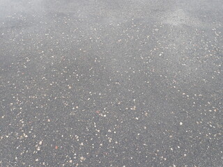 asphalt road with broken cracks after rain