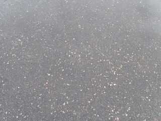 asphalt road with broken cracks after rain