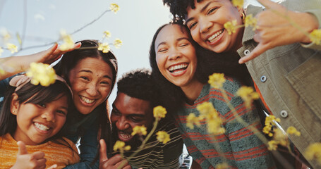 People, friends and portrait with flowers field for summer adventure, hug and nature in countryside. Group, park and bonding for holiday, social networking and blue sky for sunshine or spring