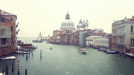 A scenic view of a canal in Venice, featuring historic buildings and boats on a winter day.