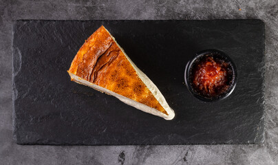 Cheesecake Slice on Slate with Berry Sauce on the Side