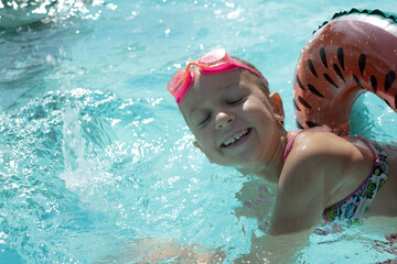 Child in goggles and swim ring