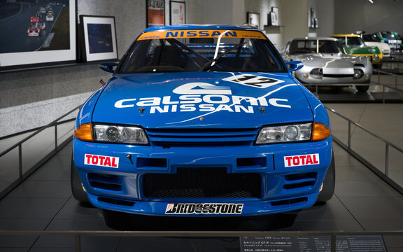 FUJI, JAPAN - 23 NOVEMBER 2024: ON DISLPAY AT THE FUJI SPEEDWAY MOTOR MUSEUM, VINTAGE MOTORSPORT ICON, THE CALSONIC NISSAN SKYLINE R32 GT-R, FRONT VIEW OF CAR WITH HEADLIGHTS, BUMPER, HOOD