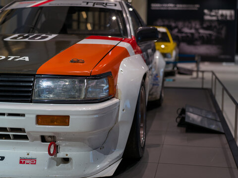 FUJI, JAPAN - 23 NOVEMBER 2024: ON DISLPAY AT THE FUJI SPEEDWAY MOTOR MUSEUM, VINTAGE MOTORSPORT ORIGINAL TOYOTA TRD AE86 N2-SPEC JAPANESE TOURING CAR IN RACING LIVERY. DETAIL FOCUSSED ON HEADLIGHT