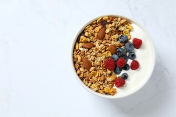 Delicious granola with berries and yogurt on a light background