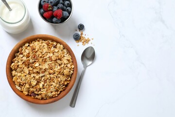 Delicious granola with berries and yogurt on a light background
