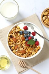 Delicious granola with berries and yogurt on a light background