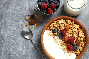 Delicious granola with berries and yogurt on a light background