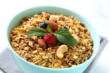Delicious granola with berries and yogurt on a light background
