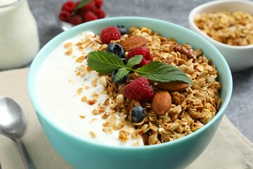 Delicious granola with berries and yogurt on a light background