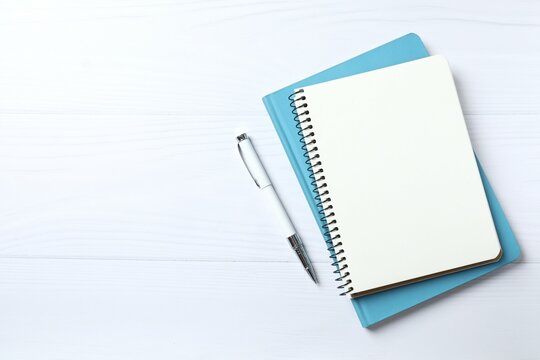 notebook with a pen on a white background, space for text