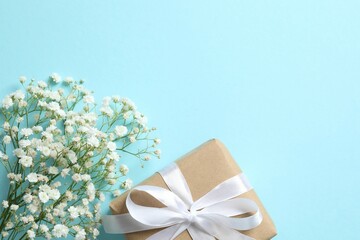 Top view photo with gift box and gypsophila flowers on color background 