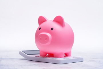 Piggy bank and calculator symbolize saving money and planning for the future. Investing in your...