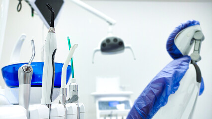 Patient chair used by  professionals for treatment and tools used by doctors in dental procedures. Dental treatment instruments and dental clinic. dental hospital and clinic  © UniqDream