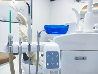 Patient chair used by  professionals for treatment and tools used by doctors in dental procedures. Dental treatment instruments and dental clinic. dental hospital and clinic  © UniqDream