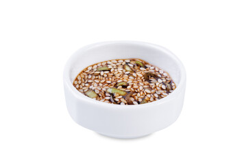 Spicy sesame seeds scallion soy sauce in a white bowl on a white isolated background