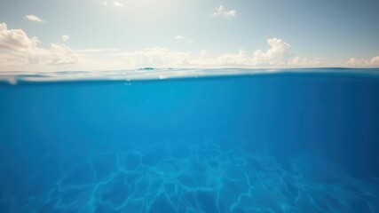 Glistening blue sea under the sunny and cloudy sky, revealing a world of underwater beauty, blue, sky