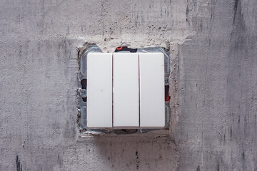 Close-Up of a wall light switch installed during renovation. Light switch mounted on an unfinished wall, representing electrical work in progress.