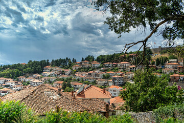 Historical part of old town Ohrid is located next to the lake and spread all over the hill with fortress of king Samuel at the top.  Dramatic clouds in the sky.
