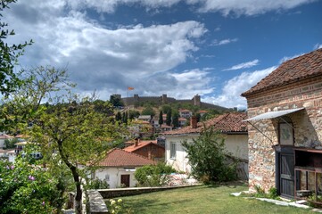 Historical part of old town Ohrid is located next to the lake and spread all over the hill with fortress of king Samuel at the top.  Dramatic clouds in the sky.